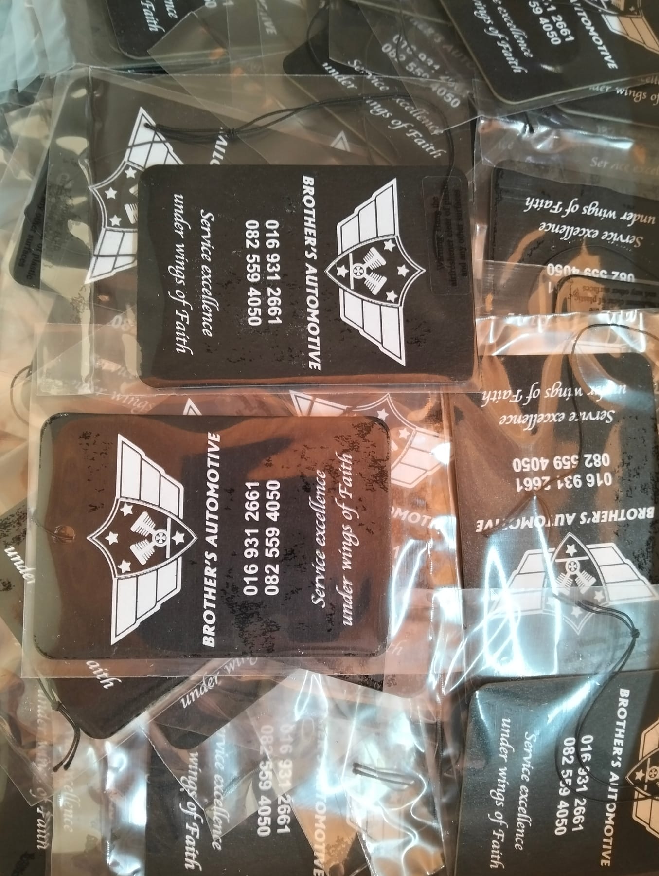 Black credit card shaped Brother's Automotive air fresheners printed in white, individually sealed