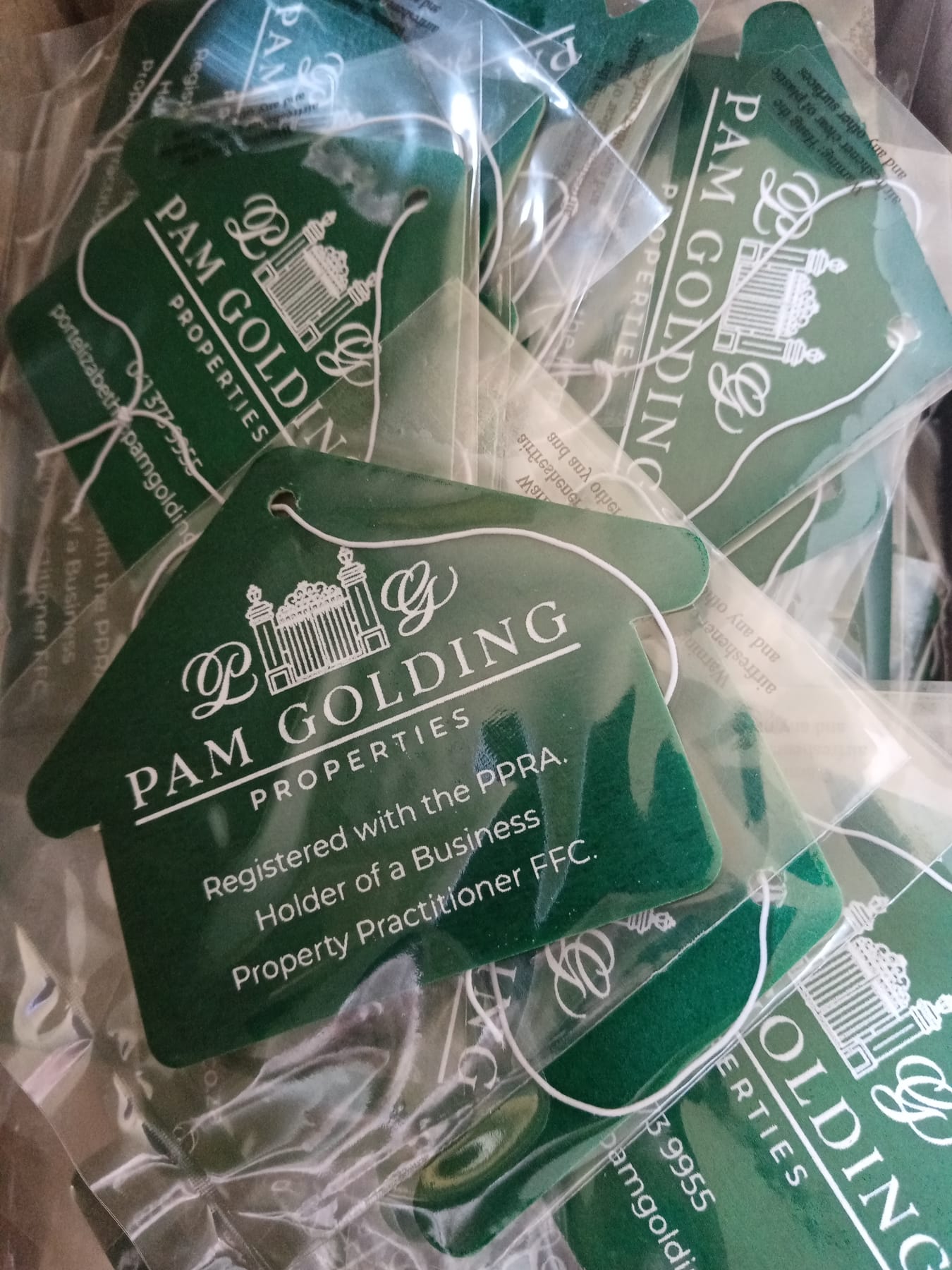 Green house shaped branded air fresheners for Pam Golding Properties, individually sealed