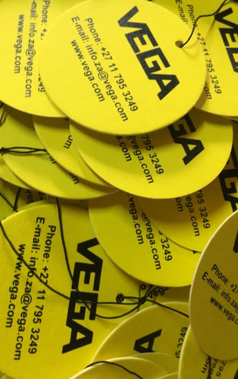 Yellow round branded air fresheners printed with the Vega logo