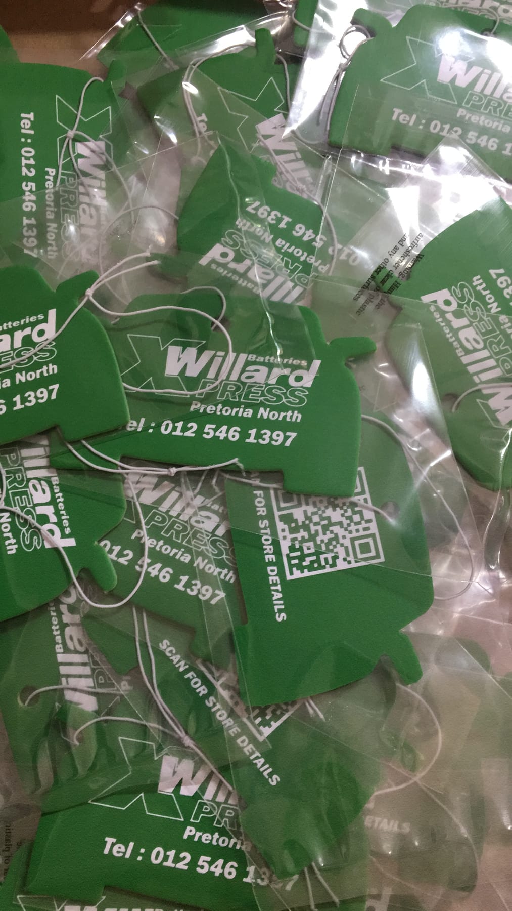 Green car shaped Willard Batteries air fresheners in sealed packets